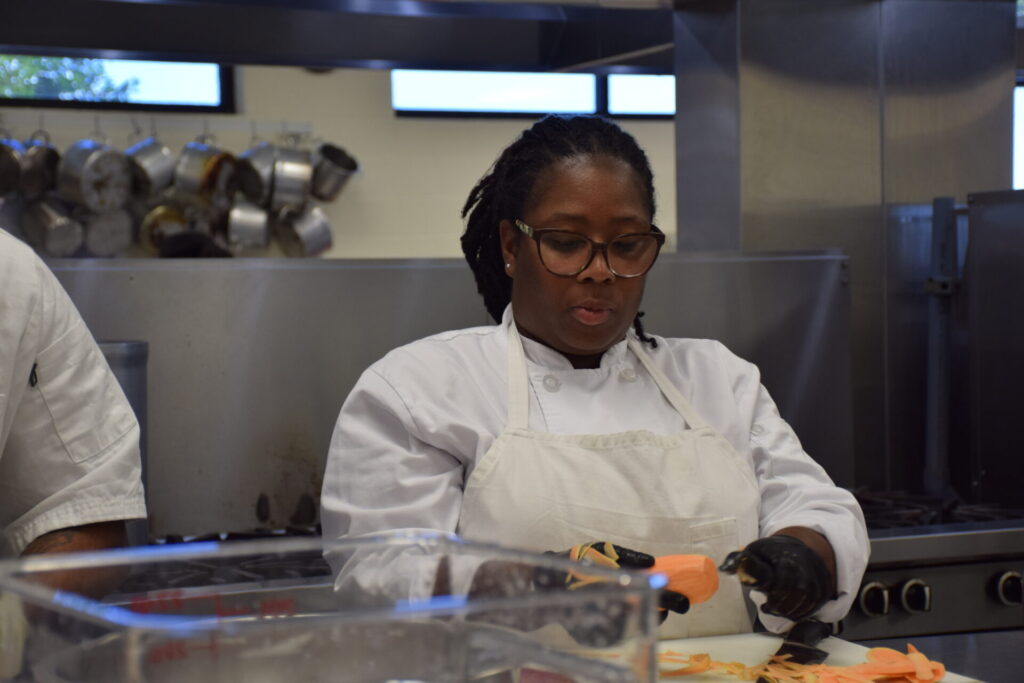 Photo of Culinary students prepping sweet potatoes