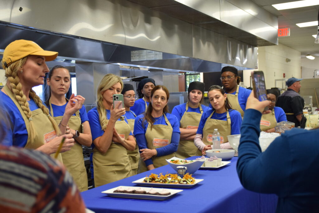 Photo of influencers presenting their dishes to judges.